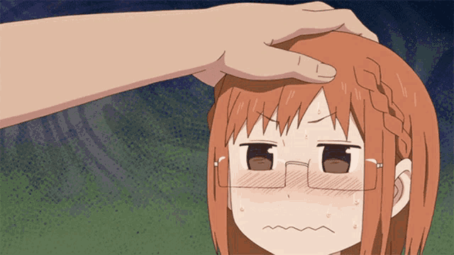 a hand is touching a girl 's forehead with an angry face
