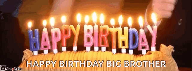 a birthday cake with lit candles that say happy birthday