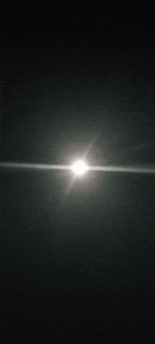 the sun is shining brightly in the dark night sky .