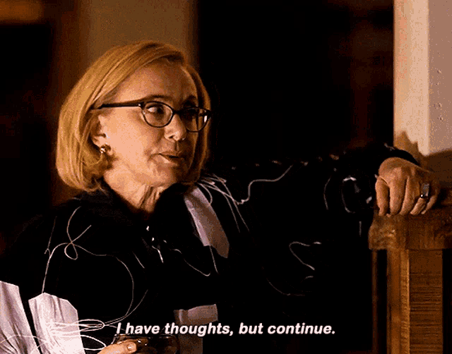 a woman with glasses is holding a glass and saying i have thoughts but continue