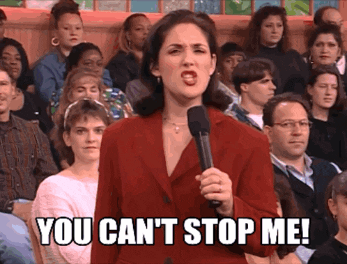 a woman speaking into a microphone with the words you can 't stop me behind her