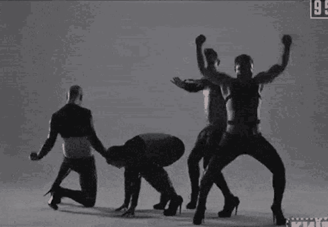 a group of people are dancing in a black and white photo