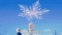 a couple of people standing in front of a fireworks display with the name quinnie written on it .