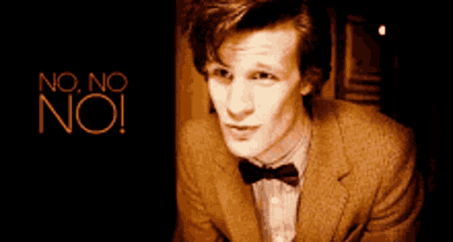 a man in a suit and bow tie says no no no !