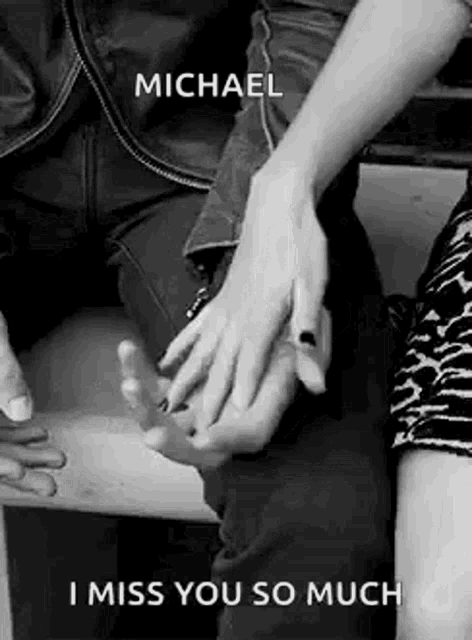 a man and a woman are holding hands on a bench and the man is saying `` i miss you so much '' .