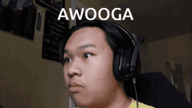 a young man wearing headphones with the word awooga on the bottom