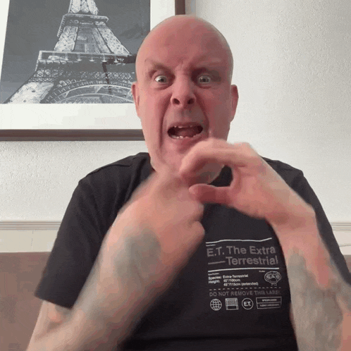a bald man wearing a shirt that says e.t. the extra terrestrial