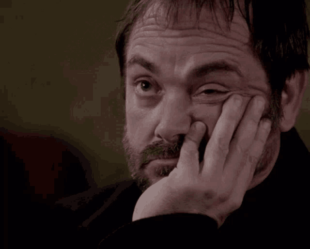 a man with a beard holds his hand to his face with the words kill me written below him