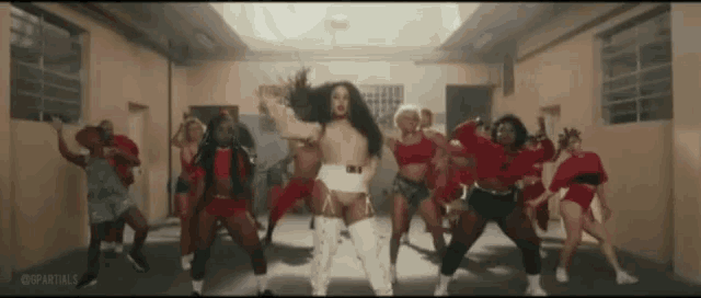 a group of women are dancing in a room with a caption that says @partials
