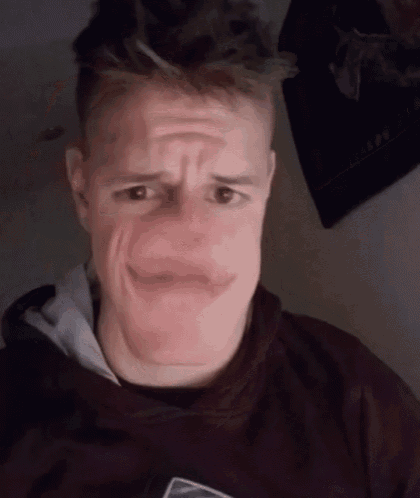 a man making a funny face while wearing a black shirt