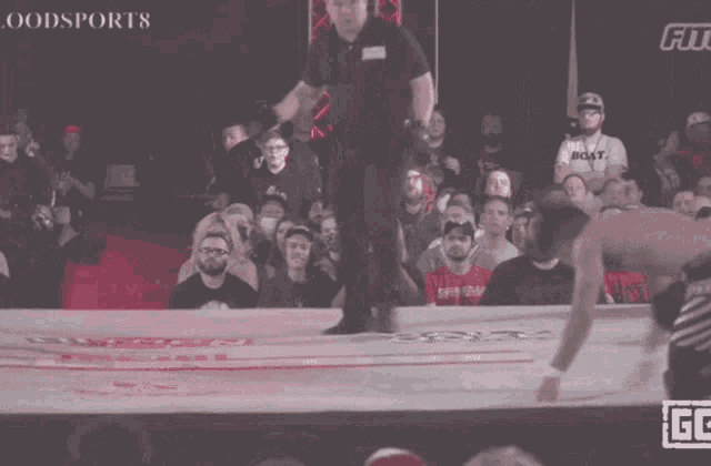 two men are fighting in a boxing ring with the words goodsports on the bottom