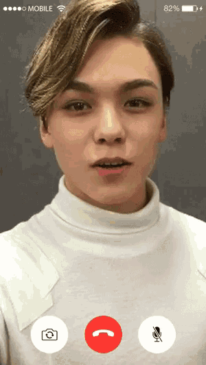 a young man is on a video call with a phone that says mobile on the top