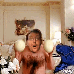 a man without a shirt is holding two balls in his hands with a gif jif watermark on the bottom right