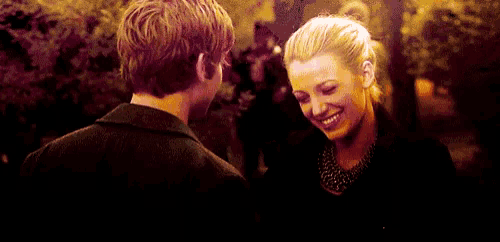 a man and a woman are looking at each other .