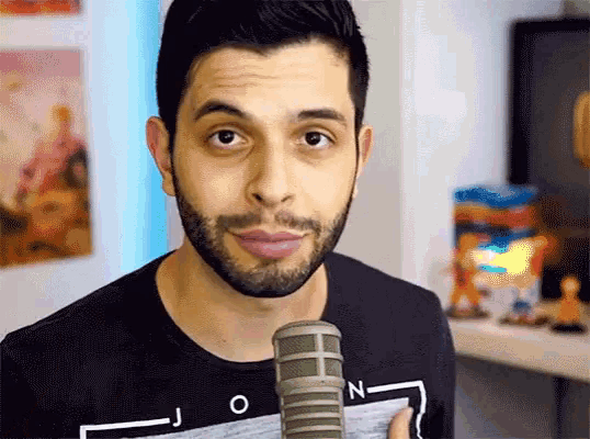 a man with a beard is wearing a black shirt that says jon on it