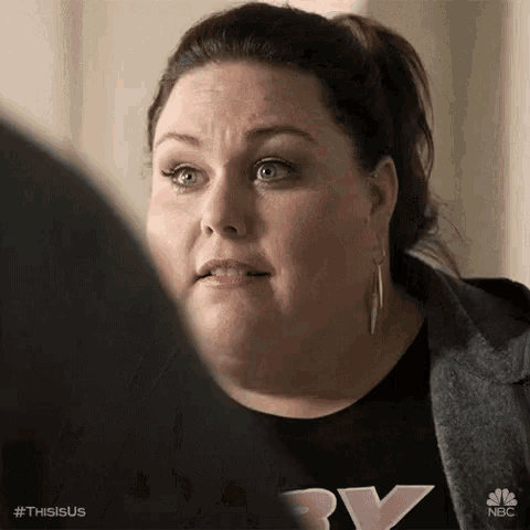 a woman with a ponytail and earrings is looking at a man .