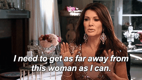 a woman is sitting at a table and says " i need to get as far away from this woman as i can . "