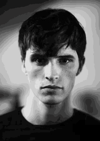 a black and white photo of a young man