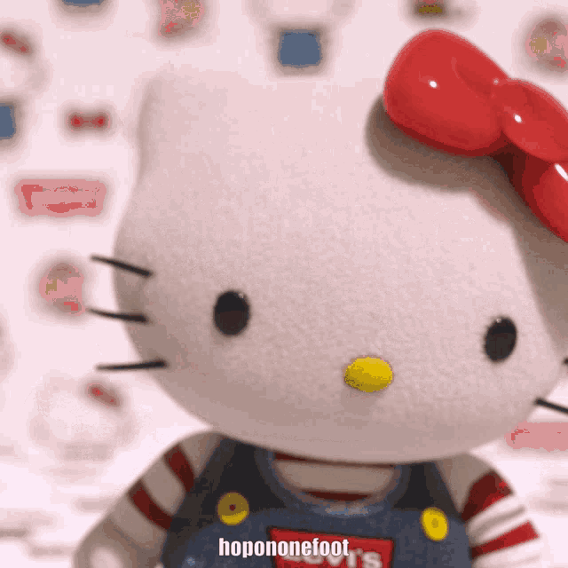 a stuffed hello kitty doll with a red bow and the words hopononefoot on the bottom