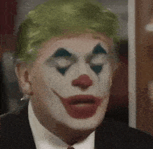 a close up of a man wearing a clown costume .