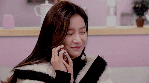a woman is smiling while talking on a phone