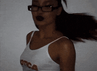 a woman wearing glasses and a tank top that says orca on it