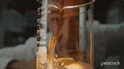 a peacock logo can be seen behind a beaker