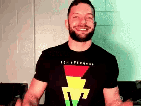a man with a beard wearing a black shirt with a lightning bolt on it is smiling .