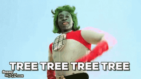 a man with green hair and red gloves is wearing a superhero costume .