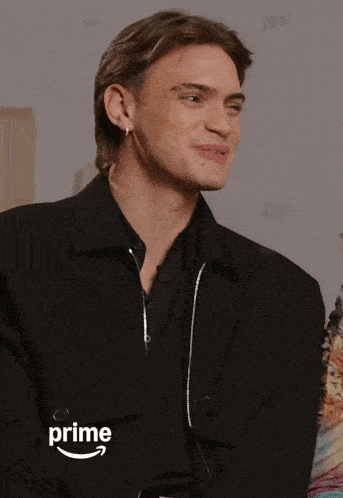 a man in a black jacket with the word prime on the bottom right