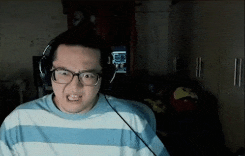 a man wearing glasses and headphones is making a funny face .