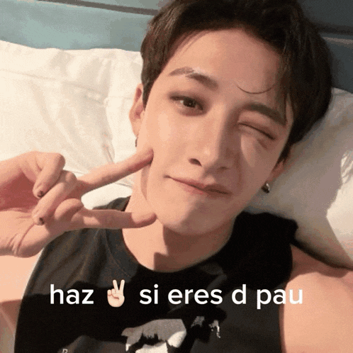 a man laying on a bed with a peace sign and the words haz si eres d pau below him