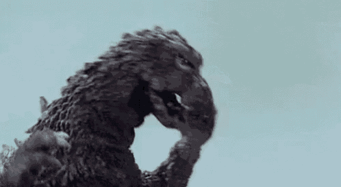 a black and white photo of a statue of a monster .