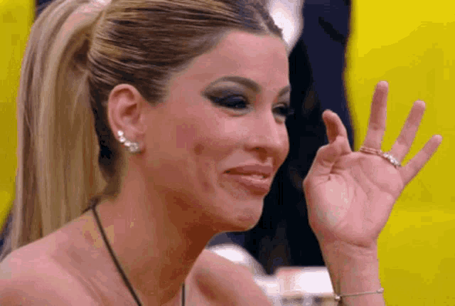 a woman with a ponytail is making a funny face