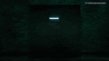 a man in a suit stands in a doorway with the game awards written on the bottom