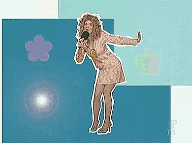 a woman in a pink dress is singing into a microphone with a flower in the background