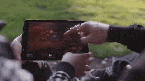a person is holding a tablet with a game on it