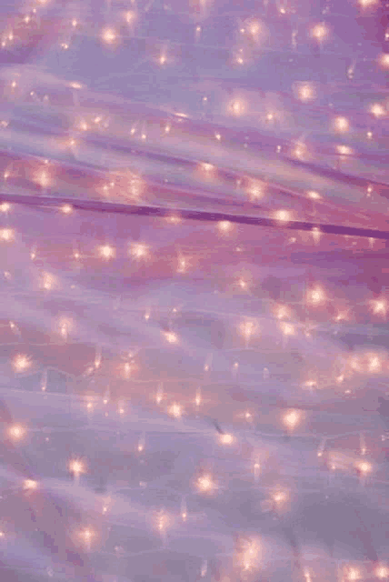 a close up of a purple cloth with lights on it .