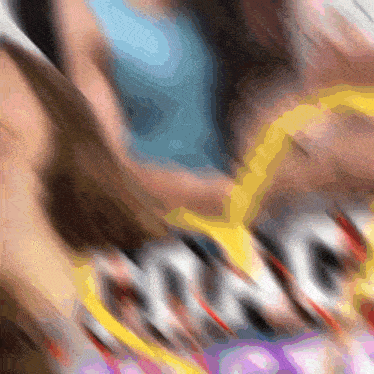 a blurry picture of a person holding a yellow object with the word king written on it