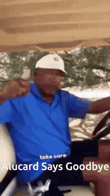 a man wearing a blue shirt and white hat is driving a golf cart and says goodbye