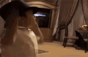 a man wearing a top hat is standing in a room