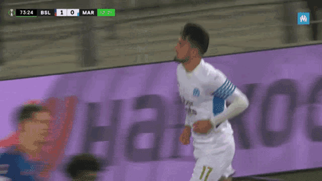 a soccer player celebrates after scoring a goal during a game between bsl and mar