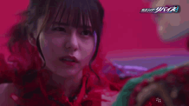 a close up of a woman 's face with the word kamen rider on the bottom left