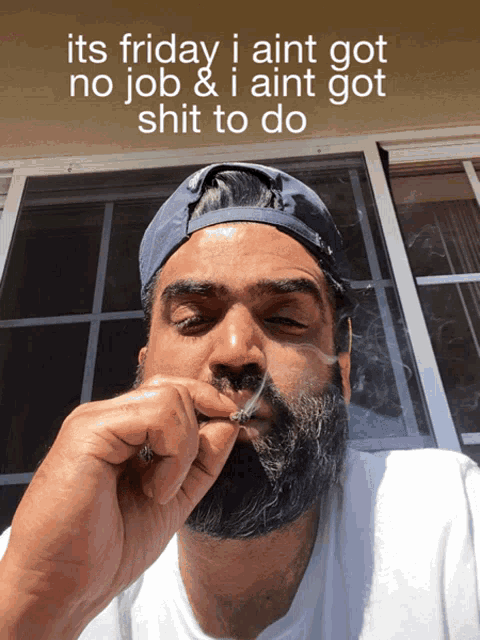 a man with a beard is smoking a cigarette with the caption " its friday i ain t got no job