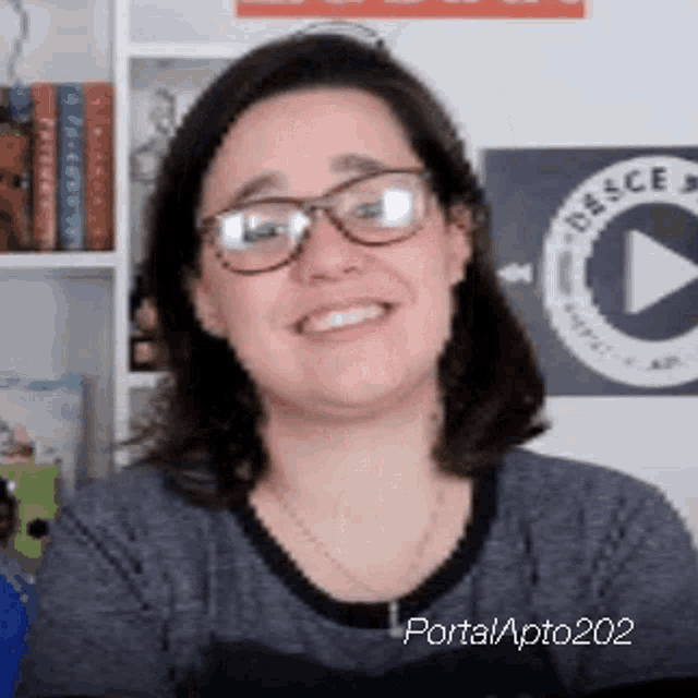 a woman wearing glasses is smiling for the camera .