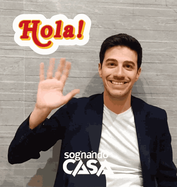 a man waves his hand in front of a sign that reads hola