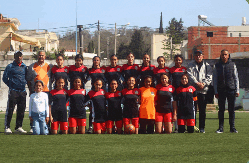 a group of female soccer players pose for a photo