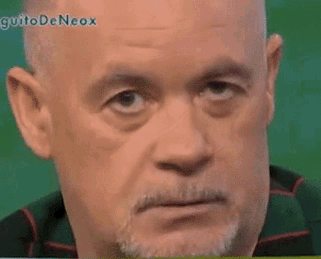 a close up of a man 's face with guitodeneox written on the bottom