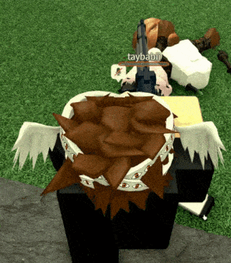 a video game character named taybabiii is laying on the grass with a gun