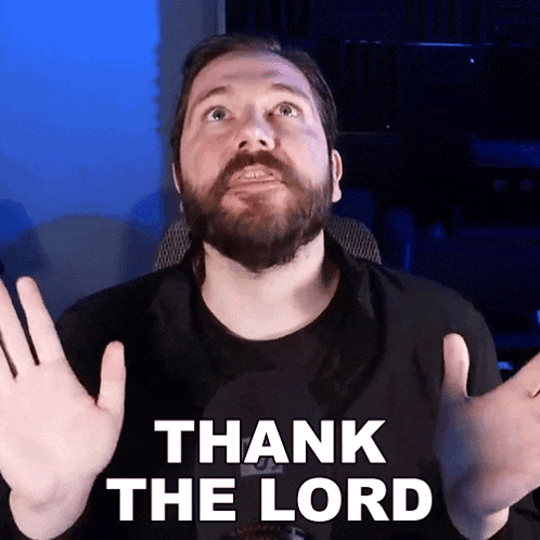 a man with a beard says thank the lord in front of a microphone